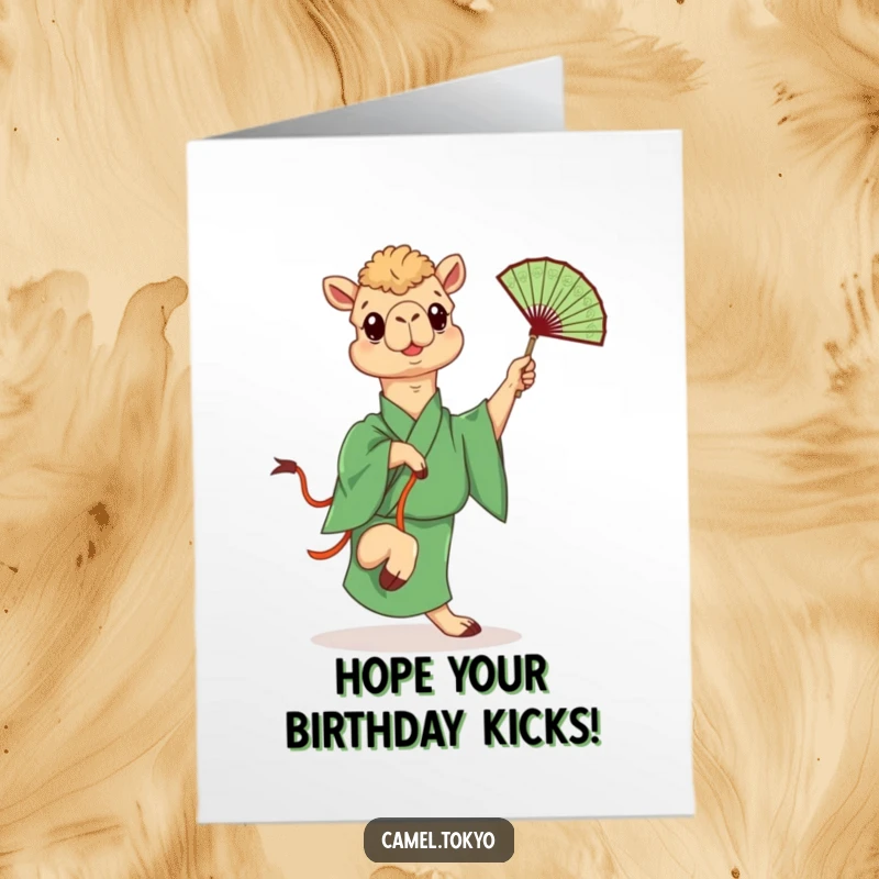 Funny Free Printable Birthday Card: Camel in green kimono playfully kicking a decorative fan, adding a humorous and energetic vibe to birthday wishes.